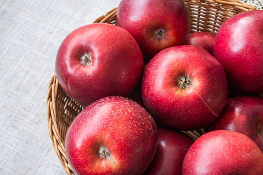 A basket of fresh red apples symbolizing health and wellness benefits of apple polyphenols.