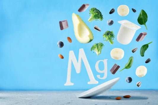 Illustration of magnesium-rich foods like avocado and broccoli with 'Mg' symbol on a blue background.