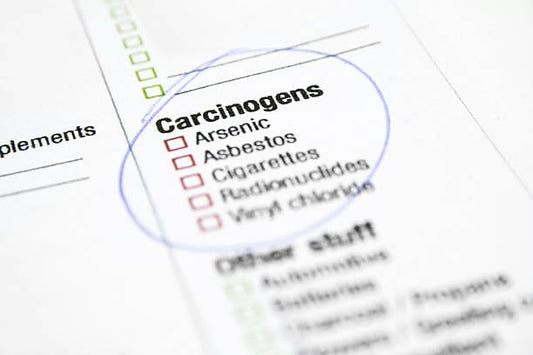 Close-up of a document highlighting carcinogens like arsenic and asbestos.