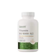 OstroVit Vitamin D3 4000 IU + K2 dietary supplement, 100 vegan tablets in a white bottle with nature-inspired design.