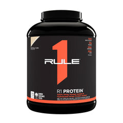 Rule One R1 Protein powder container in Birthday Cake flavor, featuring 25g protein per serving and gluten-free formula.