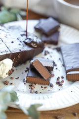 Close-up of AbsoRICE Move Bar pieces drizzled with chocolate on a white plate.