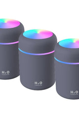Set of 3 H2O air humidifiers in grey with colorful LED lights for aromatherapy and improved air quality.
