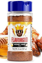 FlavorGod Honey BBQ Rub bottle next to honey and grilled chicken wings, perfect for enhancing barbecue flavor.