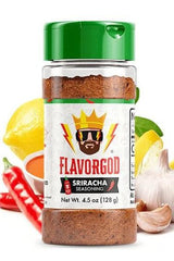 FlavorGod Sriracha Seasoning bottle with garlic, lemon, and chili peppers arranged around it.
