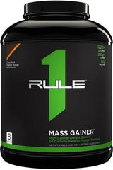 Rule One Mass Gainer protein supplement tub designed for muscle growth and recovery with chocolate peanut butter flavor.