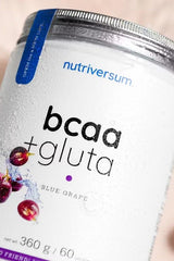 Nutriversum BCAA + GLUTA supplement container in Blue Grape flavor, featuring a sugar-free formula.