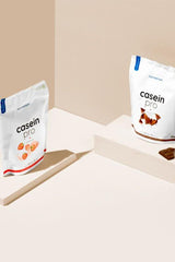 Nutriversum Casein Pro protein powder in strawberry and chocolate flavors, showcasing resealable packaging.