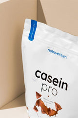 Nutriversum Casein Pro chocolate flavor protein powder package on neutral background.