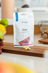 Nutriversum Liver Support supplement packaging with tablets on a wooden surface, surrounded by fresh fruits.