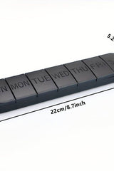 Oly Maxi Pill Box showing seven compartments for daily medication, measuring 22cm x 5.2cm in sleek black design.