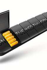 Oly Maxi Pill Box in black with seven compartments labeled for each day of the week, ideal for organizing medications.