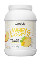 OstroVit WHEYlicious protein shake in Creamy Peach flavor, 700g container for athletes and active lifestyles.