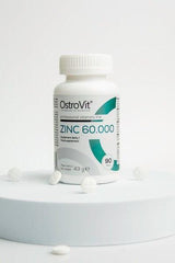 OstroVit Zinc 60.000 dietary supplement bottle with 90 tablets on display.