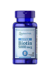 Puritan's Pride Biotin 5000 mcg dietary supplement bottle, 60 capsules for healthy skin, hair, and nails.