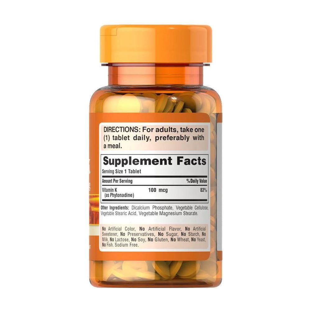 Puritan's Pride Vitamin K 100 mcg supplement bottle with tablets, promoting normal blood coagulation. Puritan's Pride Vitamin K 100 mcg supplement bottle with tablets, promoting normal blood coagulation.