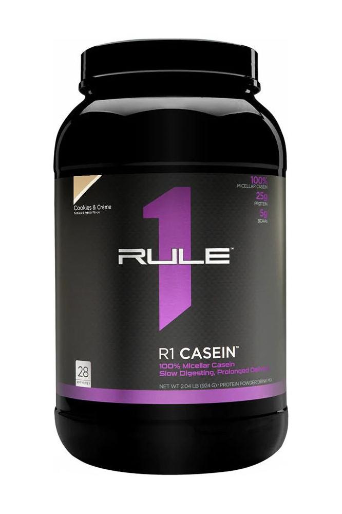 Rule One R1 Casein protein powder tub, featuring 25g slow-release protein per serving.