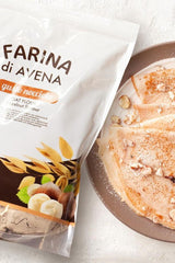 Smile Crunch flavored oat flour package with hazelnut pancakes on a plate.