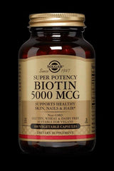 Solgar Super Potency Biotin 5000 MCG supplement bottle for healthy skin, nails, and hair, 100 vegetable capsules.