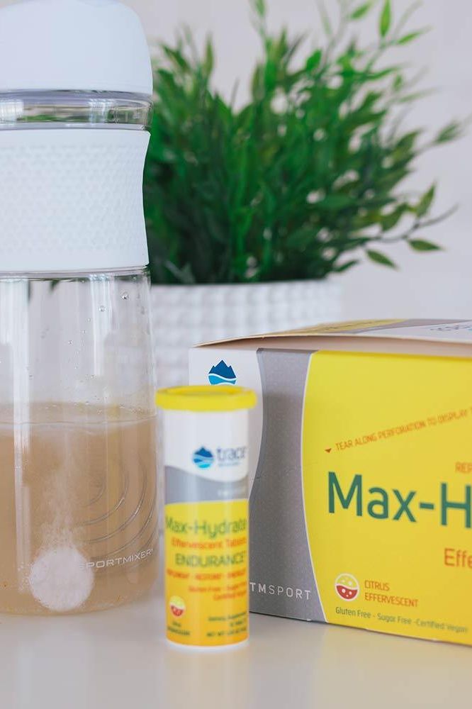 Trace Minerals Max-Hydrate Endurance Citrus tablets beside a water bottle and a green plant. Trace Minerals Max-Hydrate Endurance Citrus tablets beside a water bottle and a green plant.