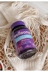 Vitabiotics Wellwoman Gummies bottle with berry flavor, containing 22 nutrients for women's health support.