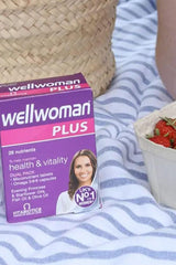 Vitabiotics Wellwoman Plus Omega 3-6-9 tablets for women's health and vitality, placed with a basket and fresh strawberries.