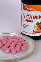 Vitaking Vitamin D3 2000 IU chewable tablets in strawberry flavor on a plate next to the bottle.