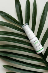 Vitamin360 D-4000 oral spray on palm leaves, providing a refreshing way to boost vitamin D intake.