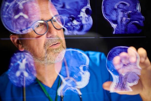 Doctor analyzing brain scans for dementia prevention and brain health research.