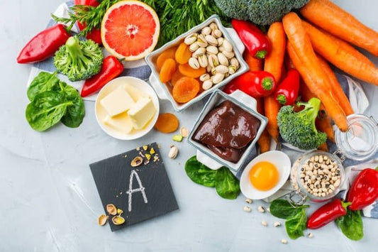 A vibrant arrangement of foods rich in vitamin A, including vegetables, nuts, and fruits, showcasing healthy nutrition.