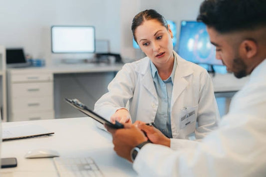 Doctor discussing health information with patient in a modern office.