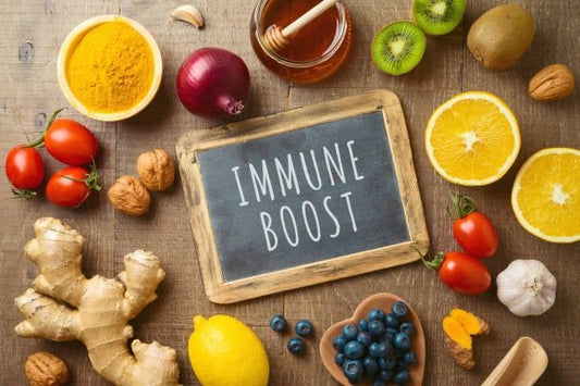 Fresh fruits, vegetables, and spices around a chalkboard labeled 'Immune Boost'.