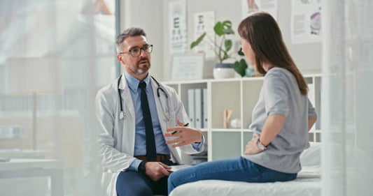 Doctor consulting with a patient about IBS symptoms in a modern clinic.