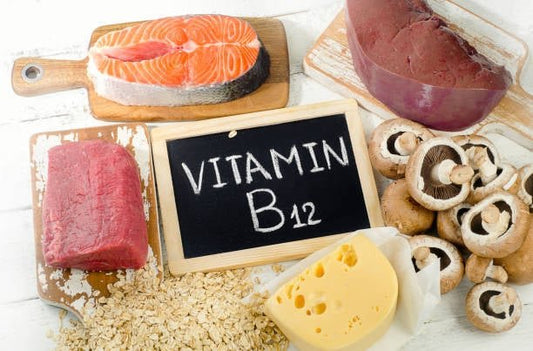 Various food sources of vitamin B12 including salmon, meat, cheese, mushrooms, and oats on a wooden background.