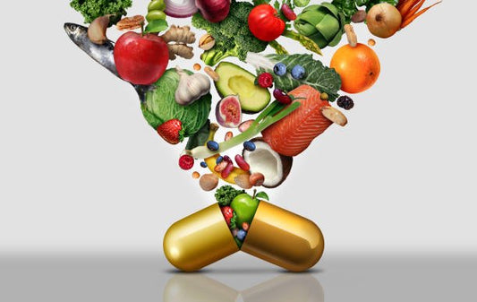 Colorful vegetables and fruits spilling from a large vitamin capsule, symbolizing multivitamins and health.