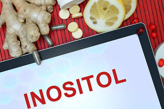 Table displaying inositol supplements alongside ginger, lemon, and pills, highlighting the importance of inositol.
