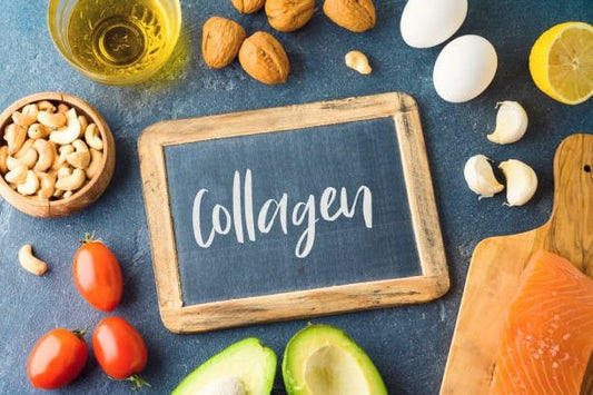 Collagen written on a chalkboard surrounded by healthy foods like nuts, eggs, fish, and vegetables.