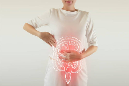 Woman with hands on abdomen, illustrating gut health and probiotics benefits for women's wellness.