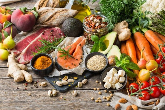 Colorful array of fresh foods including vegetables, meat, fish, nuts, and grains for healthy meal combinations.