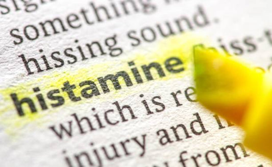 Close-up of the word histamine highlighted in a dictionary, illustrating its significance in health discussions.