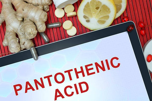 Image of a tablet displaying the text "PANTOTHENIC ACID" surrounded by ginger, lemon, and various supplements.