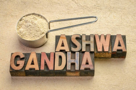 Ashwagandha spelled with vintage letters alongside a measuring scoop of ashwagandha powder.