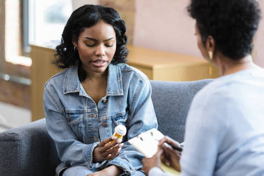 A woman discussing her medication with a therapist during a counseling session.