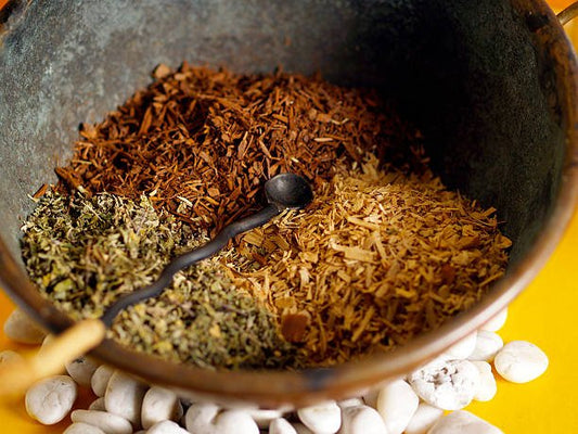 Bowl containing various herbal mixtures including Yohimbe, with a measuring spoon.