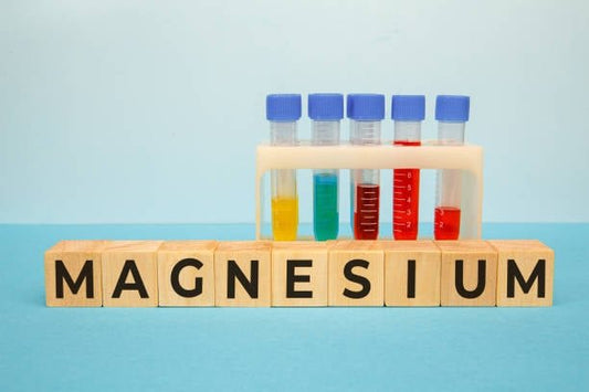 Test tubes and blocks spelling magnesium, highlighting its importance in health and biochemical processes.