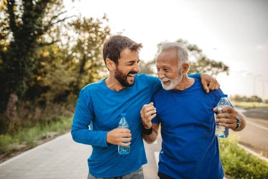 Two men jogging together, enjoying exercise and healthy lifestyle with water bottles in hand.