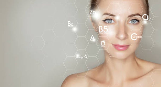 Woman with glowing skin and hexagonal labels of vitamins and antioxidants on her face.
