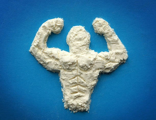 A powder sculpture of a muscular figure, representing the concept of protein and amino acids for fitness.