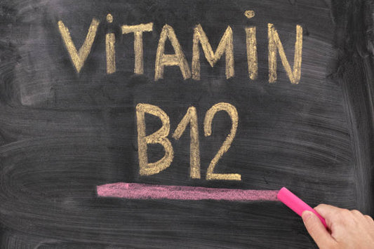 Blackboard with the words 'Vitamin B12' written in chalk, highlighting its importance for health.