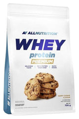 Allnutrition Whey Protein Premium 700g packaging with cookies, highlighting delicious taste and quick mixing.